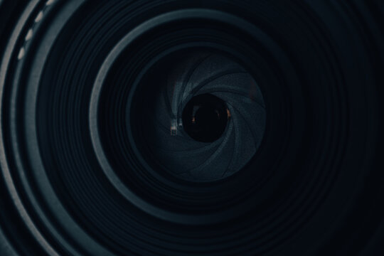 Close-up View of a Camera Lens Aperture,Macro,A detailed close-up shot focusing on the intricate iris diaphragm blades of a professional camera lens, capturing the mechanical beauty and precision.