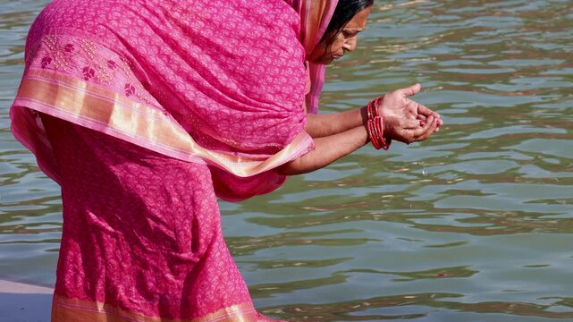 Spiritual Ritual At Holy sarayu River With Devotee Offering Reverence And Prayer