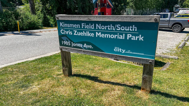 Teal City of North Vancouver sign for Chris Zuehlke Memorial Park and Kinsmen Field North and South at 1905 Jones Avenue, on weathered wooden posts.