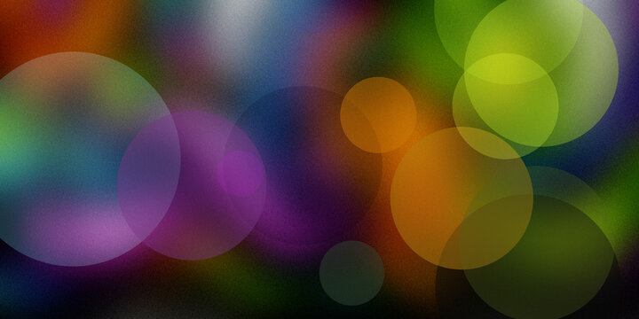 Abstract colorful bokeh light effect on dark textured background with vibrant purple green orange and blue circles composition.