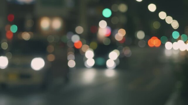 夜の街ににじむ玉ボケの光　抽象的な都市イメージの背景動画