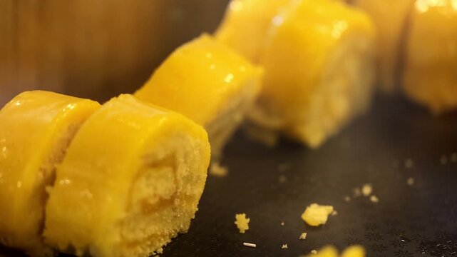 Yellow pasta or corn pieces close up on dark surface 180fps Captured in Cinematic High Detail Footage