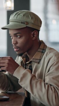 Laptop, man and thinking with coffee in cafe for story ideas, editing break and remote work. Copywriter, black person or beverage with tech at diner window for blog inspiration, insight or freelancer