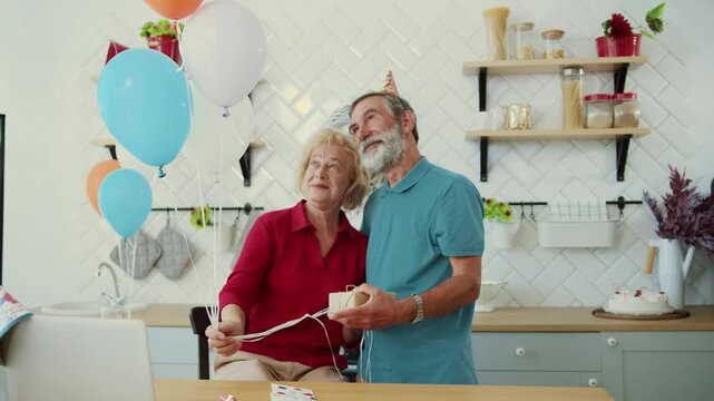 Celebrating Together A Joyful Senior Couple Enjoying Their Party Essentials with Smiles