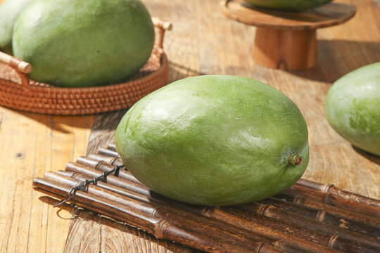 Fresh Green Kate Mangoes from Panzhihua Sichuan on Bamboo Mats - Unripe Tropical Fruit Ready to Peel