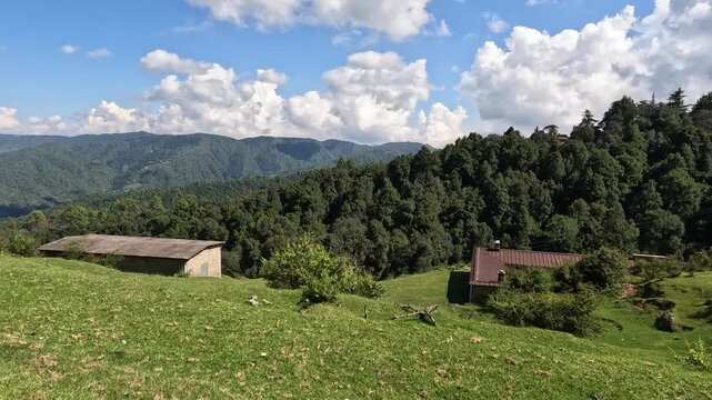 Scenic Himalayan Mountain Landscape with Green Meadows and Dramatic Clouds in Uttarakhand, India