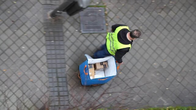 Repartidor transportista distribuidor entrega paquete pedido log&iacute;stica mensajero encargo servicio de reparto a domicilio llevar env&iacute;o bolsa y chaleco reflectante amarillo