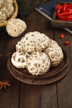 Fresh Dried Shiitake Mushrooms from Changbaishan Northeast China in Wicker Basket on Wooden Table