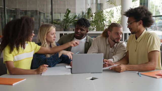 Five multiethnic diversity students friends studying with laptop emotional discussing arguing online computer study learn talking exam test learning in university college preparing for course problem