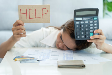 Naklejka premium Stressed and headache woman hold help with large bills or invoices, No money to pay to expenses and credit card debt. shortage, Financial problems, mortgage, loan, bankruptcy, bankrupt, poor