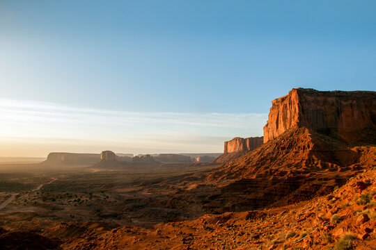 Golden sunrise over the vast Monument Valley desert