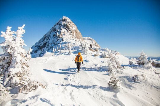 Hiker trekking up a snowy mountain slope