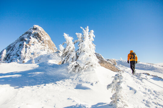 Man hiking on a sunny winter day in the mountains