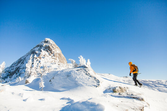 Person hikes through a snowy mountain wilderness