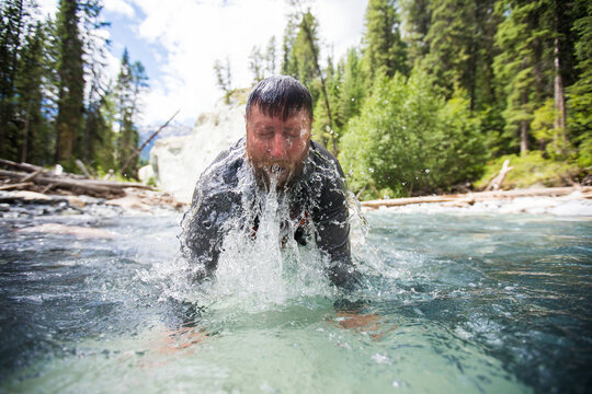 Man emerges from cold river water splashing