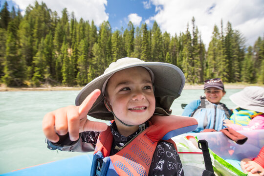 Smiling boy pointing on a scenic river float