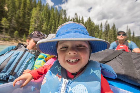 Happy young boy smiling on a family rafting trip