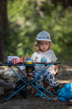 Little girl with serious expression at a campsite