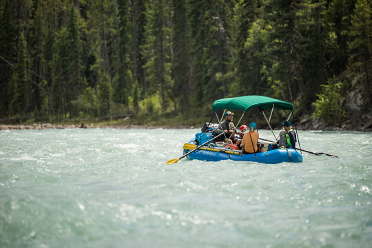 Group of friends whitewater rafting on a river