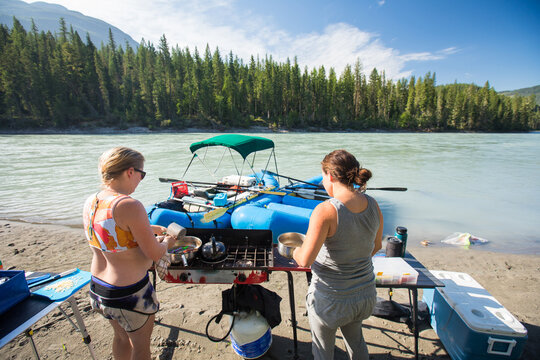 Friends cooking breakfast on a river rafting trip