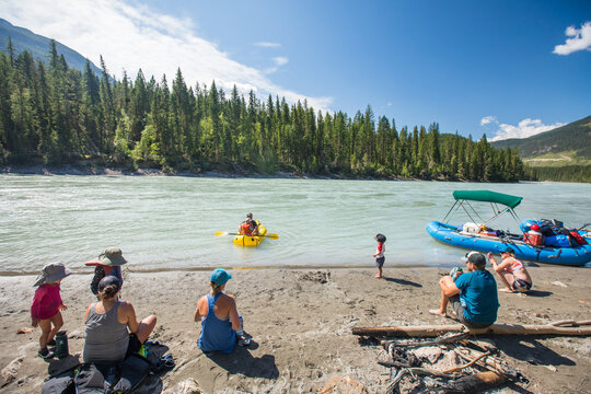 Group of friends relaxing by a mountain river