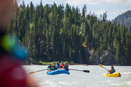 People rafting on a scenic mountain wilderness river