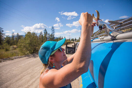 Woman prepares her raft for a river adventure