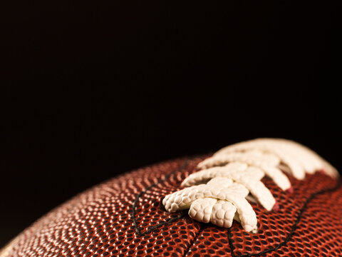 American football centered against a black background