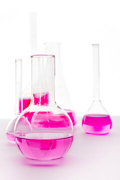 Laboratory glassware with pink liquids on isolated background, chemistry experiment concept, scientific research, education and lab analysis