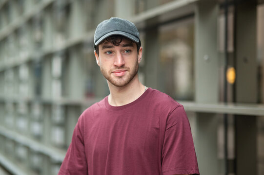 Young man wearing cap posing in urban setting
