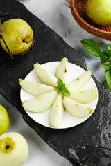 Fresh Xian Pears Sliced on White Plate with Dew Drops © CanVan