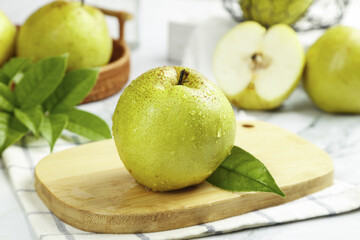 Fresh Jade Pears with Dew Drops on Wooden Board © CanVan