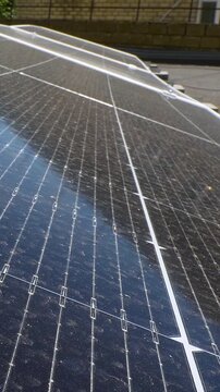 The Concept of Green Energy in an Urban Environment. Solar panels on the roofs of old apartment buildings. A rooftop solar power plant - Vetical video
