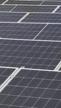 The Concept of Green Energy in an Urban Environment. Solar panels on the roofs of old apartment buildings. A rooftop solar power plant - Vetical video