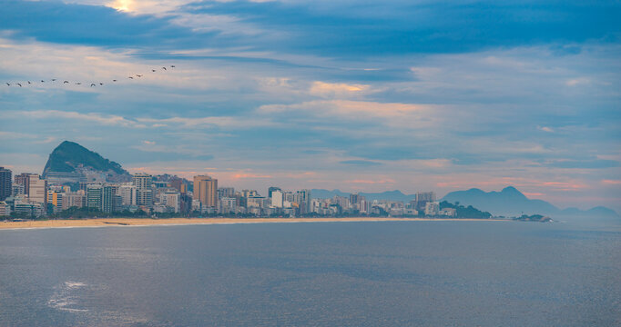  Panoramic view of ocean coastline and city skyline during cloudy sunset