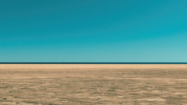Vast, flat, sun-baked terrain under a clear, expansive blue sky
