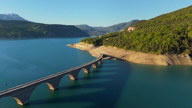 Aerial view of Chanteloube Bay, Serre-Poncon Lake with old viaduct in Durance Valley. French Alps, Hautes-Alpes, France