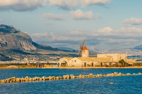 Trapani sea salt production view of old windmill at salt marches in Sicily, Italy