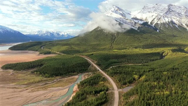 Descending drone shot over road beside Abraham Lake