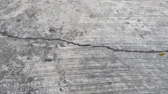 Close up texture of cracked grey concrete surface background