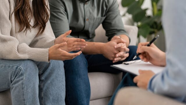 A couple participating in a supportive discussion with a therapist highlighting the significance of emotional connection and communication in a warm environment focused on mental wellness and relation