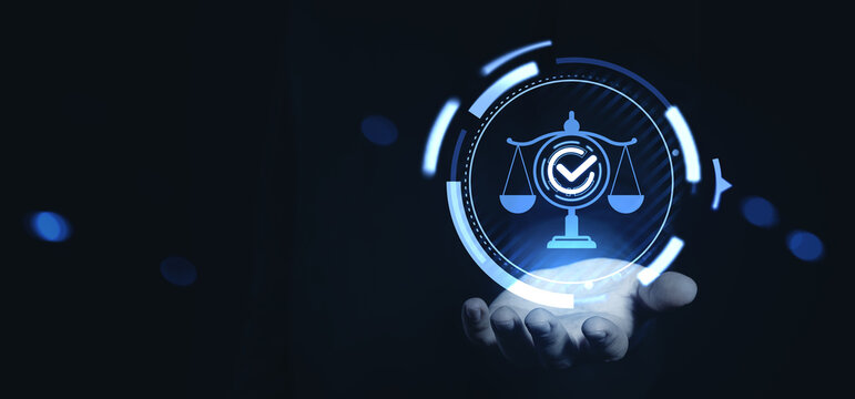 Digital justice scale with glowing checkmark hovering above hand in futuristic blue interface concept technology on dark background.