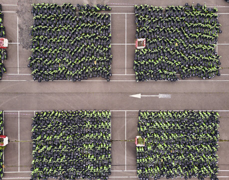 Middenmeer, Netherlands - 15 June 2026: Aerial view of hundreds of green GO Sharing electric scooters parked in dense blocks on an asphalt lot at a depot in Agriport.