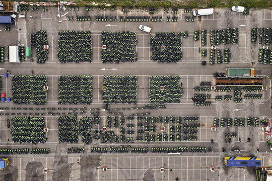 Middenmeer, Netherlands - 15 June 2026: Aerial view of hundreds of GO Sharing electric scooters parked in neat blocks at a depot in Agriport.