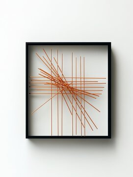 Minimalist modern wall art featuring thin copper rods arranged in a geometric black square frame