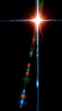 Glowing lens flare moving across an empty black background, vertical video featuring cinematic light streaks, radiant glow and elegant visual effects
