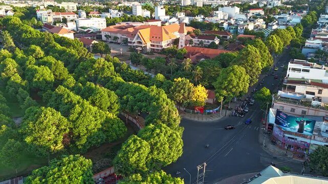 Buon Ma Thuot, Dak Lak, Vietnam - MAY 7, 2026: An architectural urban timelapse capturing the historic Bishop House in Buon Ma Thuot, Dak Lak, Vietnam. The high-angle frame beautifully balances the tr