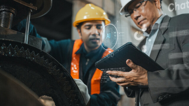 ai artificial intelligence technology Engineer and manager reviewing AI-powered manufacturing data smart factory optimizing production machine performancen industrial through digital transformation