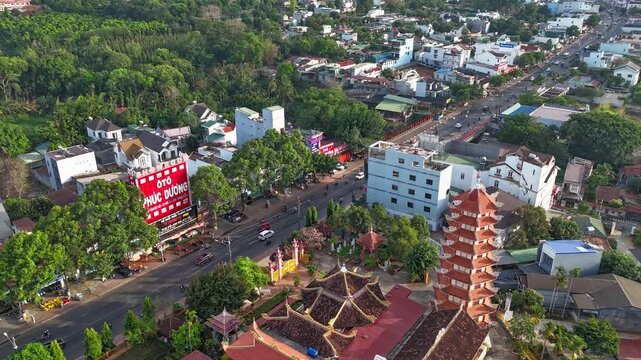 Buon Ma Thuot, Dak Lak, Vietnam - May 4, 2026: A compelling urban timelapse shot along National Highway 14 in Buon Ma Thuot, Dak Lak, Vietnam. Captured from an elevated perspective