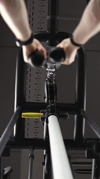 Vertical screen First person view performing a lat pulldown exercise on gym equipment showing controlled pulling motion strength training muscle activation and fitness progress
